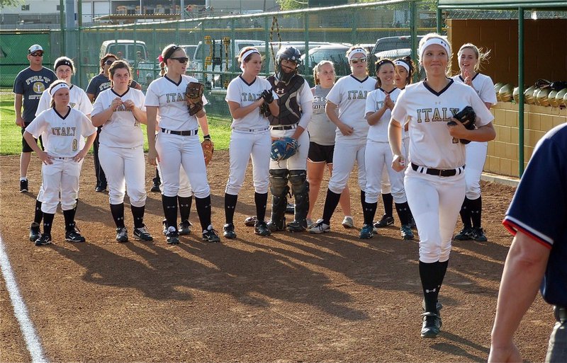 Image: Lady Gladiator, Megan Richards(17), rushes over to wish the umpires luck during the pre-game introductions.
