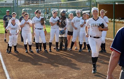 Image: Lady Gladiator, Megan Richards(17), rushes over to wish the umpires luck during the pre-game introductions.