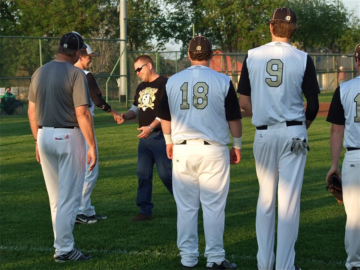 Image: On Loyd Davidson Memorial Night, Gladiator Catcher, Ross Stiles, shakes the hand of 1990 IHS Graduate, Mark Buchanan, who played four years under assistant coach Loyd Davidson, after Buchanan tossed the ceremonial first-pitch.