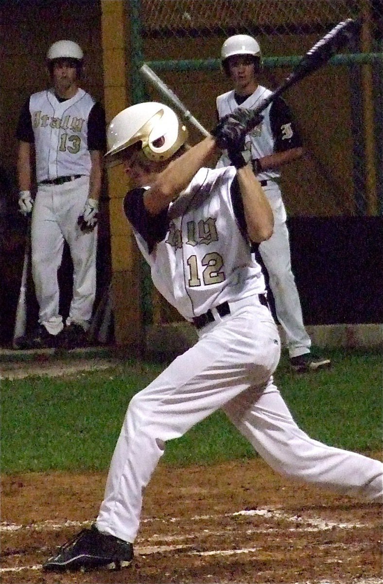 Image: Justin Buchanan(13), and, Ross Stiles(1), look on as teammate, Justin Wood(12), hits one into play.