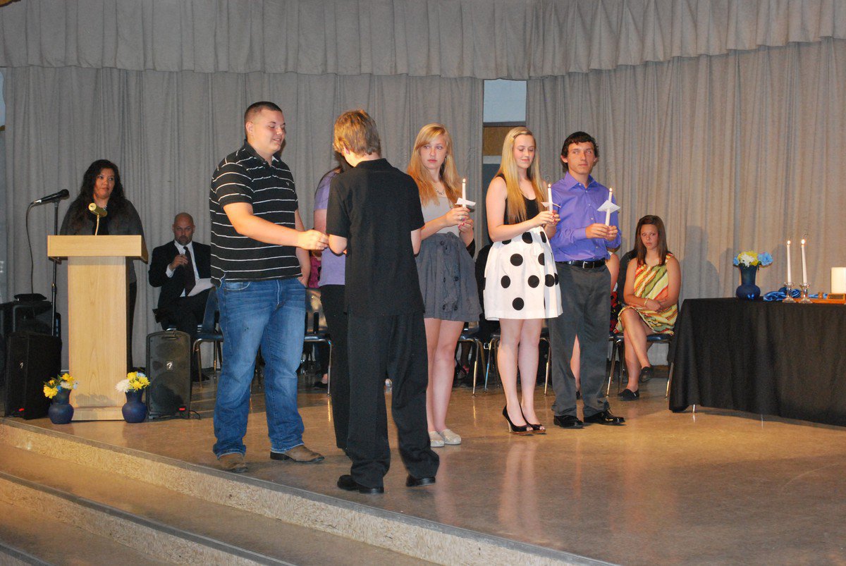 Image: Levi takes the flame from last year’s president, Kelton Bales.