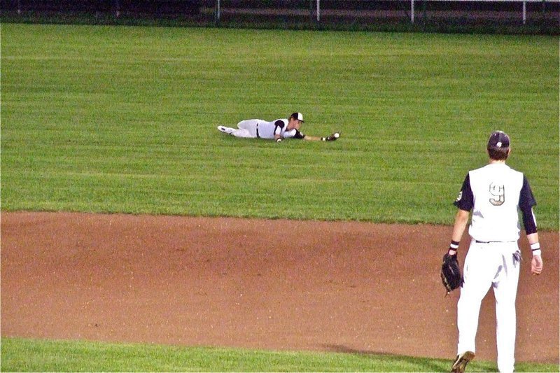 Image: Right Fielder, Jase Holden(3) dives for a ball in right field. Holden later made a gutsy catch in foul territory sliding toward the fence to catch the game’s final out.