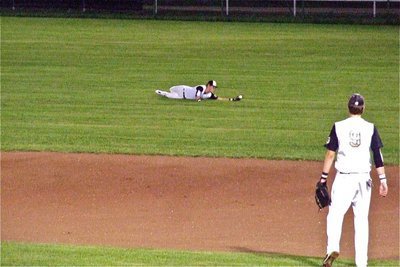 Image: Right Fielder, Jase Holden(3) dives for a ball in right field. Holden later made a gutsy catch in foul territory sliding toward the fence to catch the game’s final out.