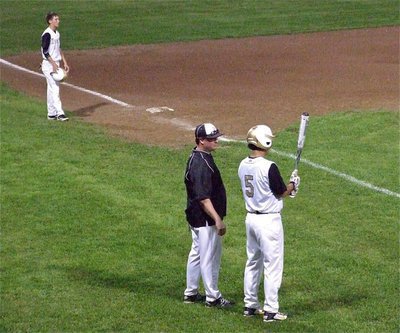 Image: With Ross Stiles(1) at third base, Gladiator head coach Josh Ward talks with slugger, Reid Jacinto(5), regarding his approach at the plate.