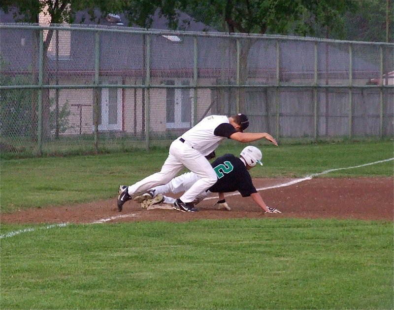 Image: Italy’s third baseman, Kyle Jackson(7), attempts to tag an Eagle runner before he lands but the call goes Rio Vista’s way.