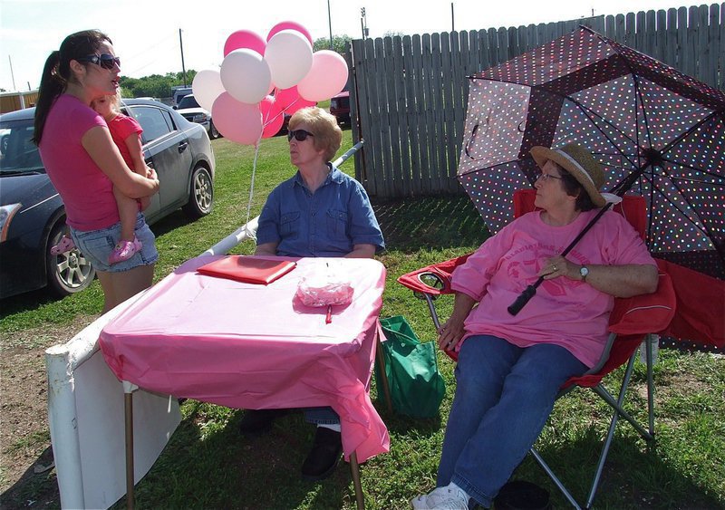 Image: Event coordinator, Jessica Simon checks on the gate donation table greeters, Birdie Bell and Karen Mathiowetz.
