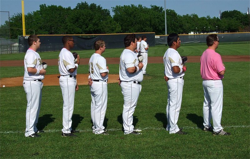 Image: JV Gladiators Tristan Smithwick, John Hiughes, Tyler Crawley, Hank Seabolt, Omar Estrada and Coach Ward show respect to the flag and our nation’s war heroes.