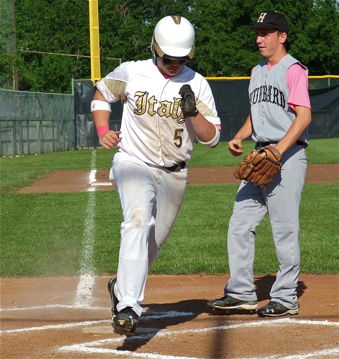 Image: Crossing home plate is Zain Byers(5) after stealing from third.