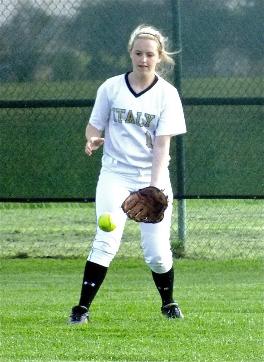 Image: Lady Gladiator, Kelsey Nelson(14) fields the ball during the warmup session before the game.