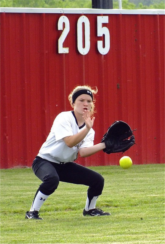 Image: Lady Gladiator, Tara Wallis(8), fields a ball during a hitting drill.