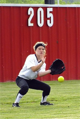 Image: Lady Gladiator, Tara Wallis(8), fields a ball during a hitting drill.