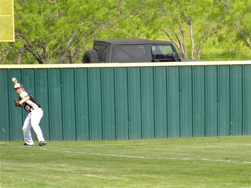 Image: In the deep corner of left field is Italy’s, Tyler Crawley, who hustles the ball back into the infield.