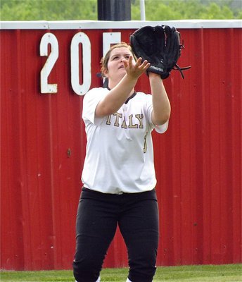 Image: Lady Gladiator, Brooke DeBorde, shags fly balls during pre-game drills.