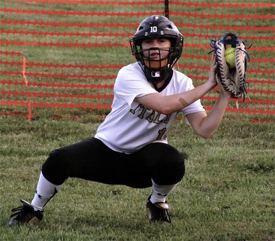 Image: Kelsey Nelson, helps warm up Italy’s pitchers at great peril to herself.