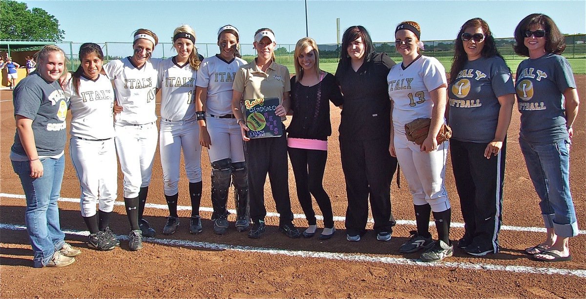 Image: Lady Gladiator head coach, Jennifer Reeves [Gold shirt], is honored by 2010 Lady Gladiator team members and coaches before Italy’s final home game of the 2012 season, in what is the final year for, Coach Reeves, as an Italy ISD faculty member and coach.