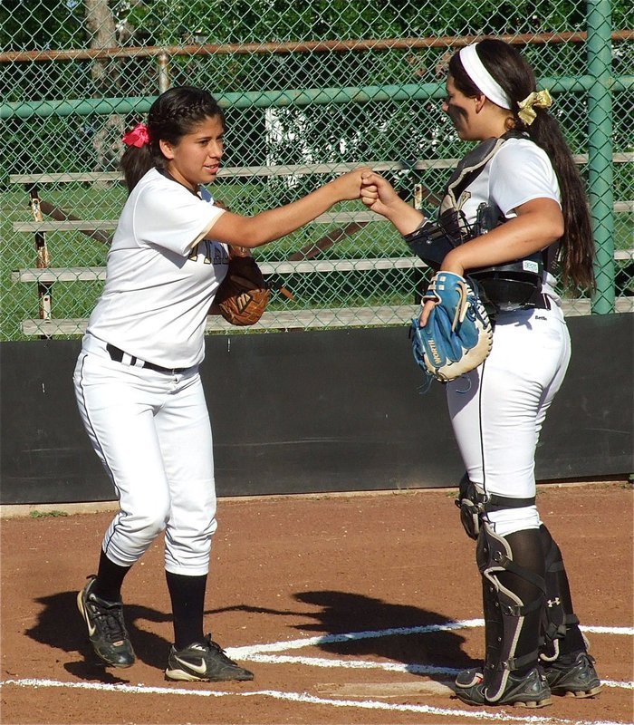 Image: Junior catcher, Alyssa Richards, wishes Lady Gladiator Senior right fielder, Alma Suaste, good luck.