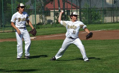 Image: Third baseman, Chace McGinnis(2), helps teammate, Tyler Anderson(11), converge on a ground ball.