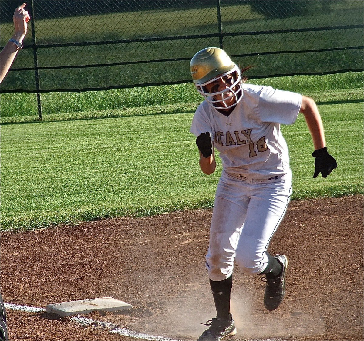 Image: Bailey Bumpus(18) gets the go home sign from Coach Reeves after an overthrown ball to third.