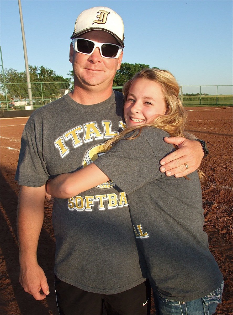 Image: Lady Gladiator manager, Britney Chambers gives her father and assistant coach Michael Chambers a hug.