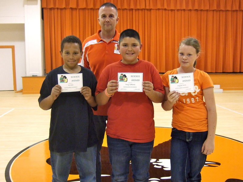 Image: Principal Tennery with his three science award winners.