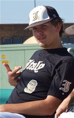 Image: Cole Hopkins points to the his town in a show of pride.