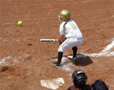 Image: Tara Wallis(8) slap hits the ball into play against Mildred.