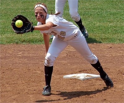 Image: Bailey Bumpus during a warmup throw down to second.