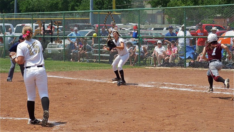 Image: Pitcher, Jaclynn Lewis(15), throws out a Mildred runner late in the contest to first baseman, Megan RIchards(17) as the Lady Gladiator faithful look on.