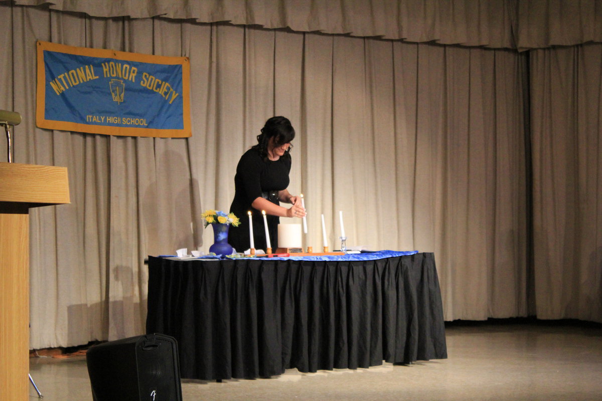 Image: Kayltyn Bales lights the “Leadership” candle.