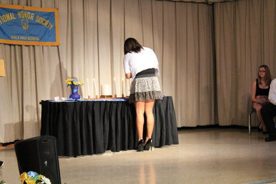 Image: Destani Anderson (senior) lights the “Citizenship” candle.