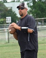 Image: Italy High School’s new athletic director and head football coach, Hank Hollywood, takes his players through the plays during spring practices.