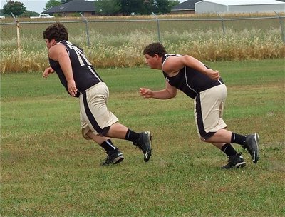 Image: Linemen Hank Seabolt(76) and John Byers(77) fire off the ball.