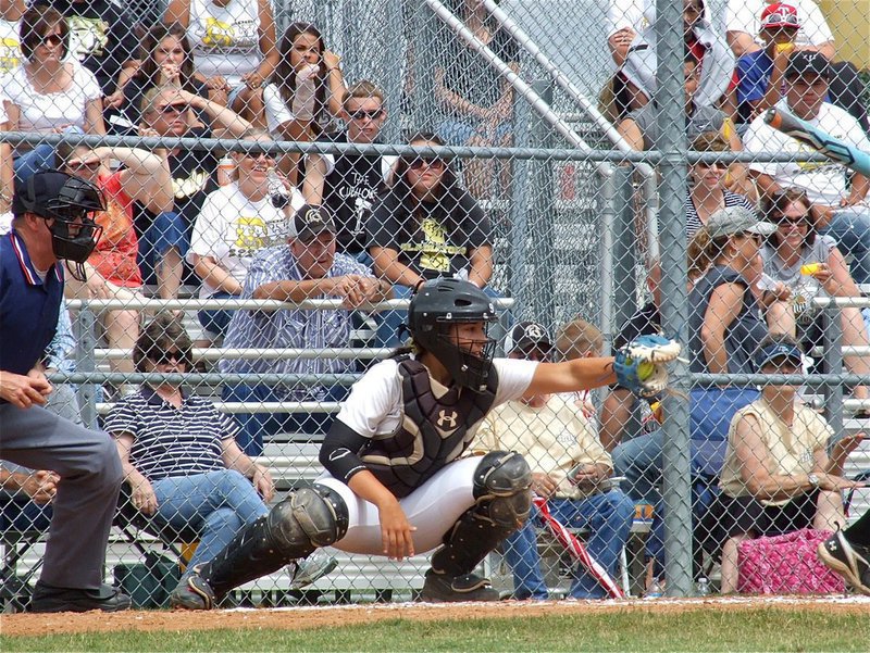 Image: Catcher, Alyssa Richards(9) pulls in a strike.