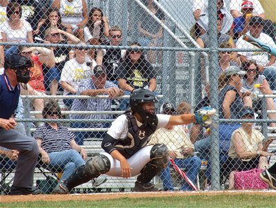 Image: Catcher, Alyssa Richards(9) pulls in a strike.