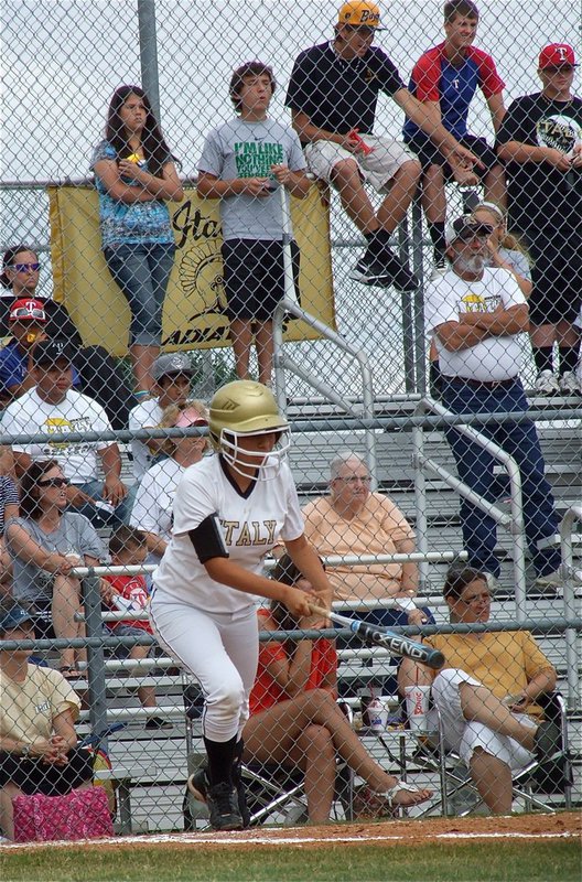 Image: Alma Suaste(7) hits a single and heads to first base for Italy.