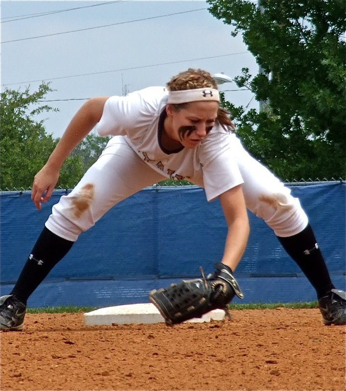 Image: Bailey Bumpus(18) sends a message to Crawford during warmups.