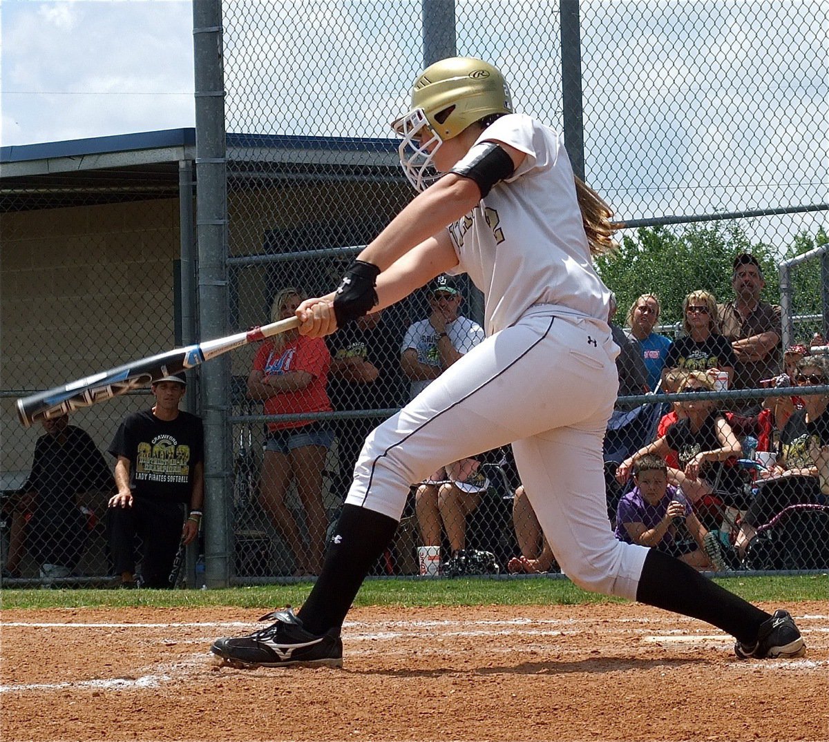 Image: Madison Washington(2) turns a low pitch into a hit.