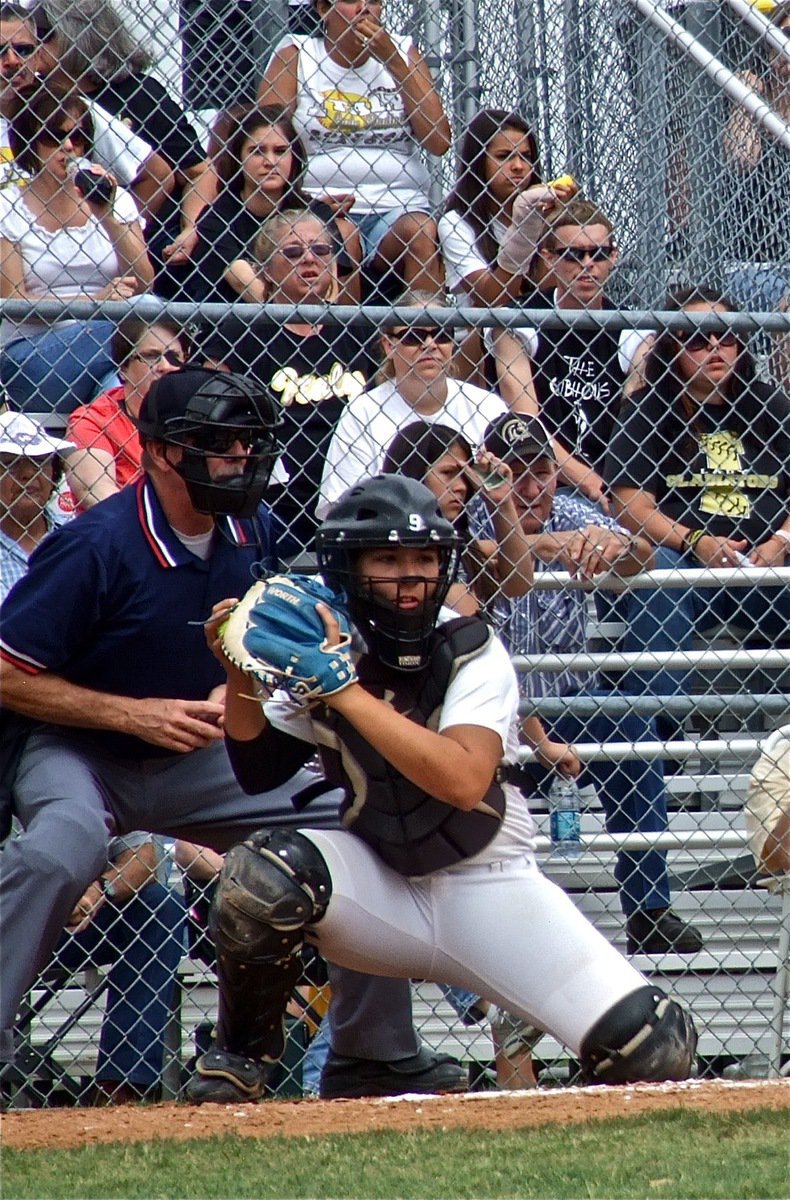 Image: Catcher, Alyssa Richards(9), surveys the bases.