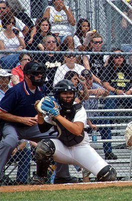 Image: Catcher, Alyssa Richards(9), surveys the bases.