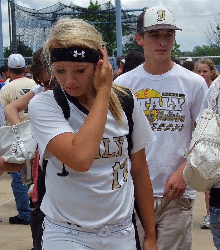 Image: Ross Stiles escorts Megan Richards(17) away from the field as the senior pitching ace carries a lifetime of memories from her stellar career with her.