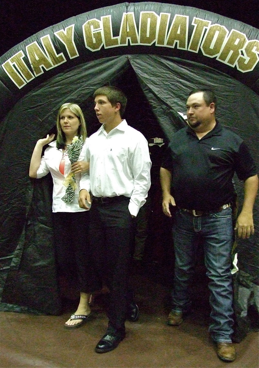 Image: Senior Gladiator, Kyle Jackson, enters the banquet thru the Italy Gladiator tunnel with his parents Sabrina and Gary Jackson.