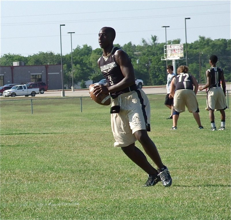 Image: Gladiator quarterback Marvin Cox drops back to throw a pass.