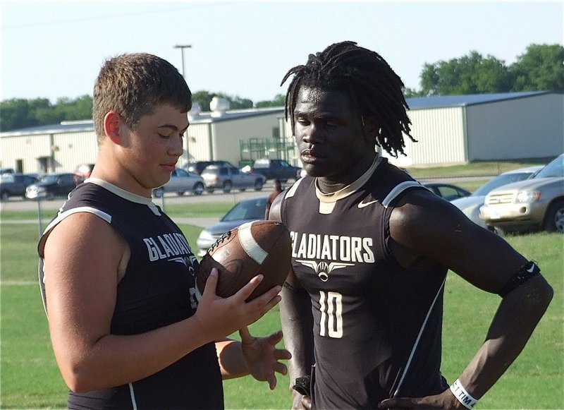 Image: Zain Byers and Ryheem Walker talk football during a break in the action.