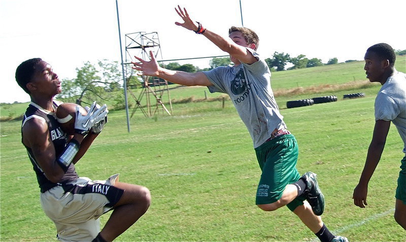 Image: Trevon Robertson cradles in a pass from Marvin Cox.