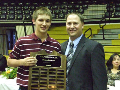 Image: Coach Josh Ward awarded Ross Stiles the Defensive MVP in baseball.