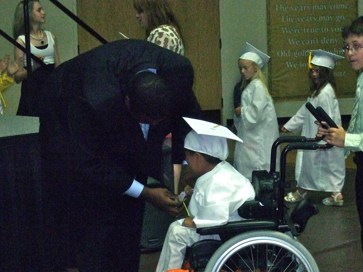 Image: Mr. Miller was proud to give this student his diploma.