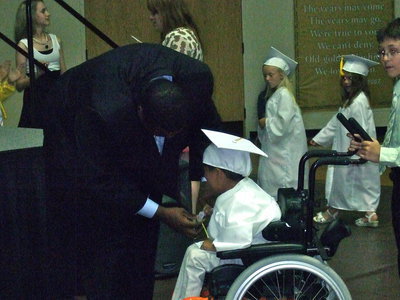Image: Mr. Miller was proud to give this student his diploma.