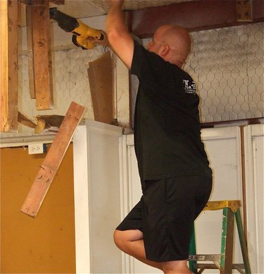 Image: Coach Hank Hollywood leads the effort to renovate the field house.