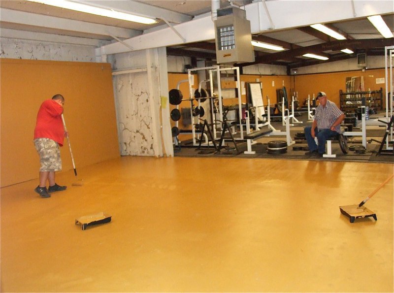 Image: Richard Cook supervises the painting of the floor.