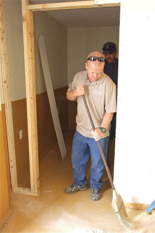 Image: Italy ISD maintenance crewmen, Michael Chambers and Bobby McBride, help clear out debris.